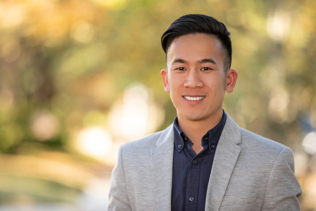 Updated professional headshot in Houston with male professional in gray jacket outdoors