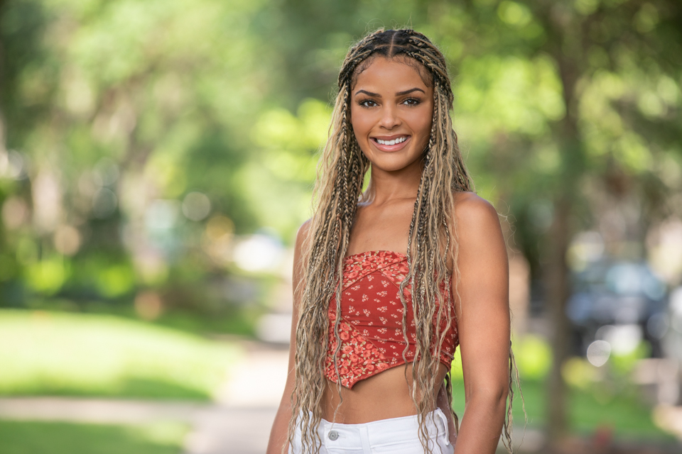 Outdoor headshot in Houston with natural light and greenery, ideal for modern professional and personal branding.