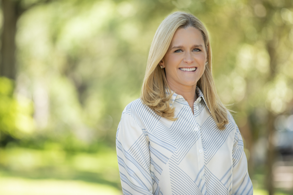 Updated professional headshot in Houston with woman in light sweater outdoors