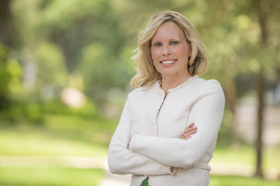 Updated professional headshot in Houston with confident female executive outdoors
