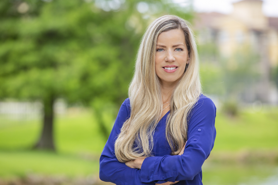 Updated professional headshot in Houston with confident woman in blue top outdoors