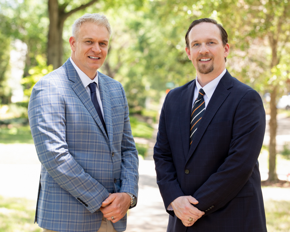 Two Houston executives photographed outdoors during a company office headshot day